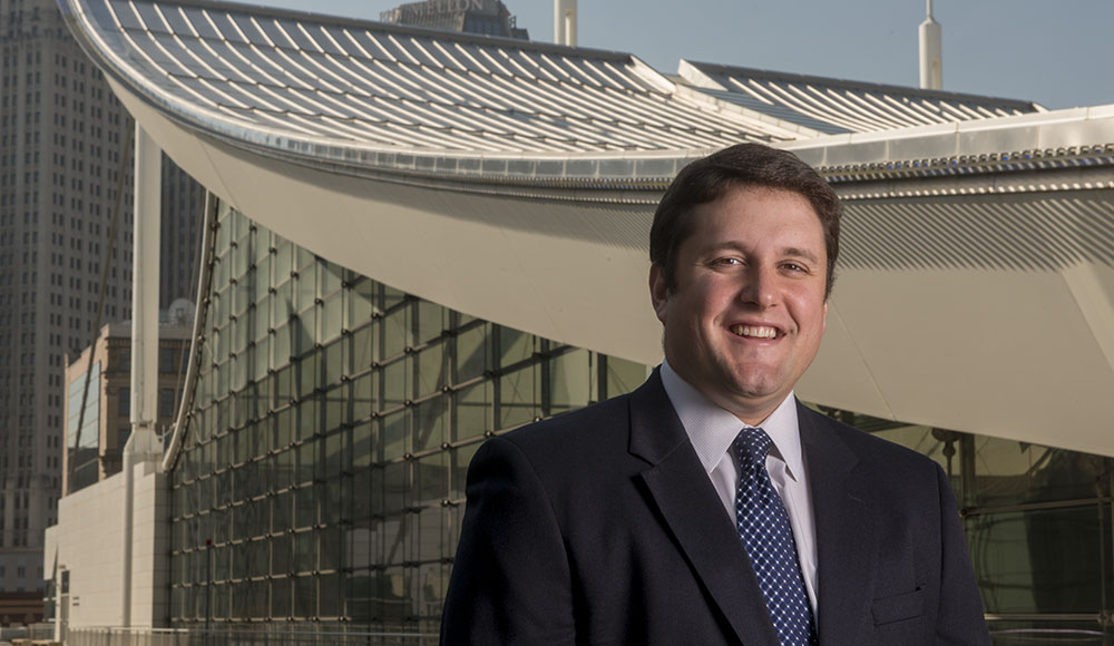 Conor McGarvey pictured in a suit standing in front of the convention center in Downtown Pittsburgh.